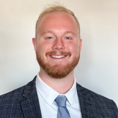 Eric Perry smiling in a blue suit