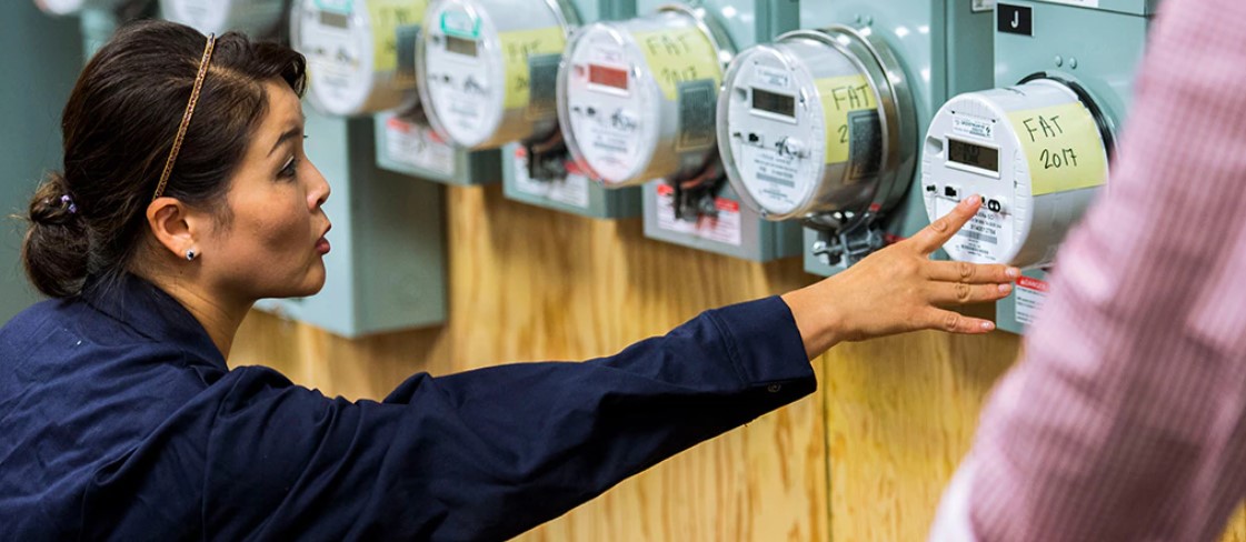 A PSE employee monitoring energy meters