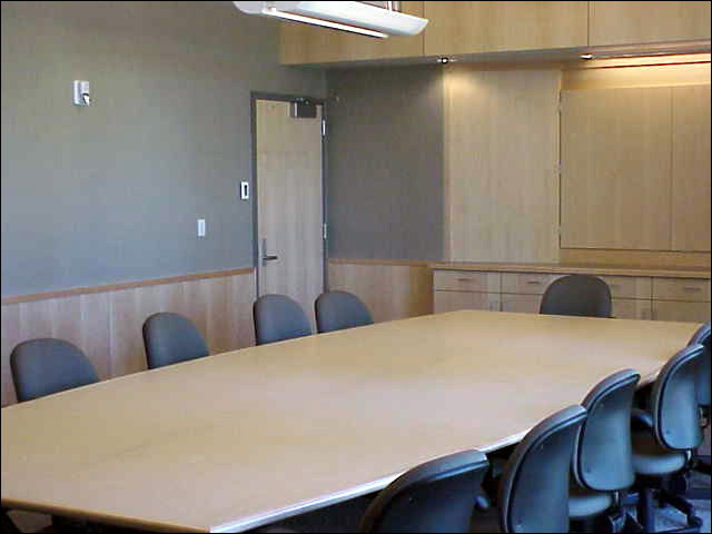 A small conference room seating 14 with a screen.