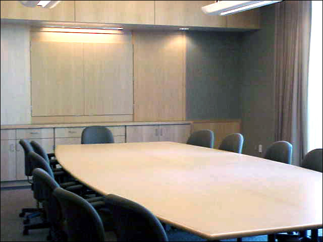 A small conference room seating 14 with a screen.