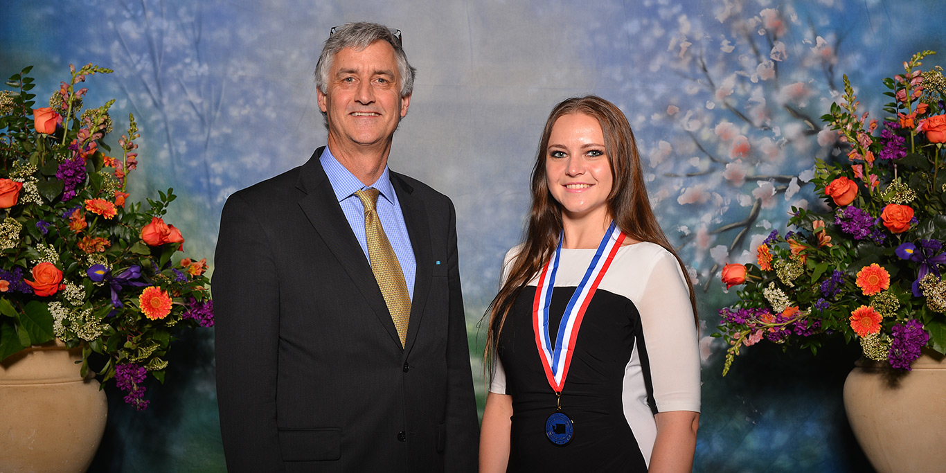 Kathryn Forman poses with her All-WA Academic Team medal next to RTC President Kevin McCarthy