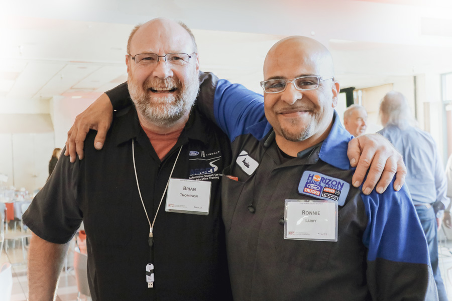 RTC instructor Brian Thompson and Ronnie Larry stands together smiling during the 2019 Student Success Breakfast