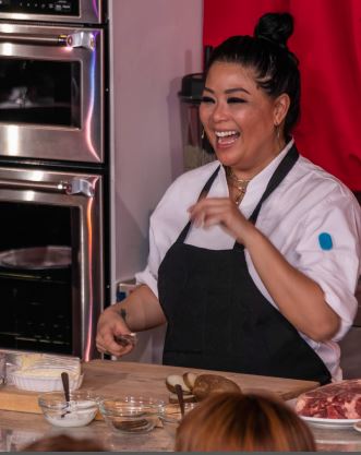 Chef Mar enjoys a laugh with dinner guests as she demonstrates a four-course meal