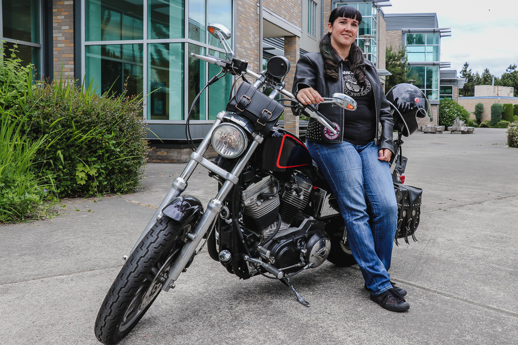 Rachel Houghton sitting on parked motorcycle in front of RTC building C