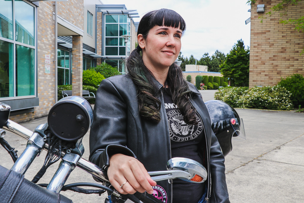 Rachel Houghton sitting on a parked motorcycle looking at something in the distanceRachel Houghton sitting on parked motorcycle in front of RTC building C