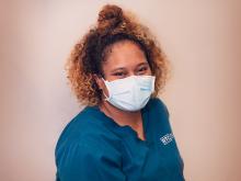 Student in blue scrubs and face mask 